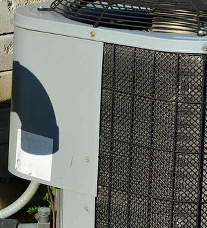 Side panel of an outdoor air conditioner with a small white label