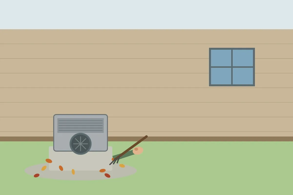 Outdoor air conditioner condenser beside a house with fallen leaves being raked away from it